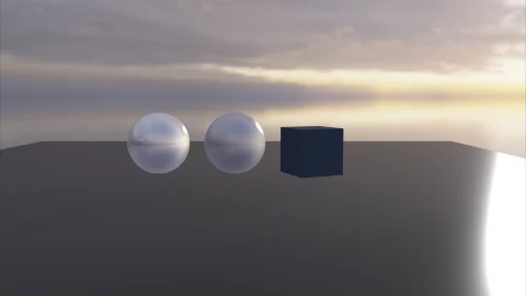 Chrome spheres and a cube lit by a sunset sky